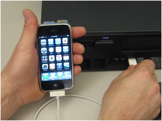 Using iTunes-connect the iPhone to the PC with a USB cable